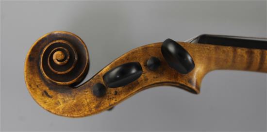 A violin bearing label for Maggini and date 1616, 14.5in., length overall 23.5in.